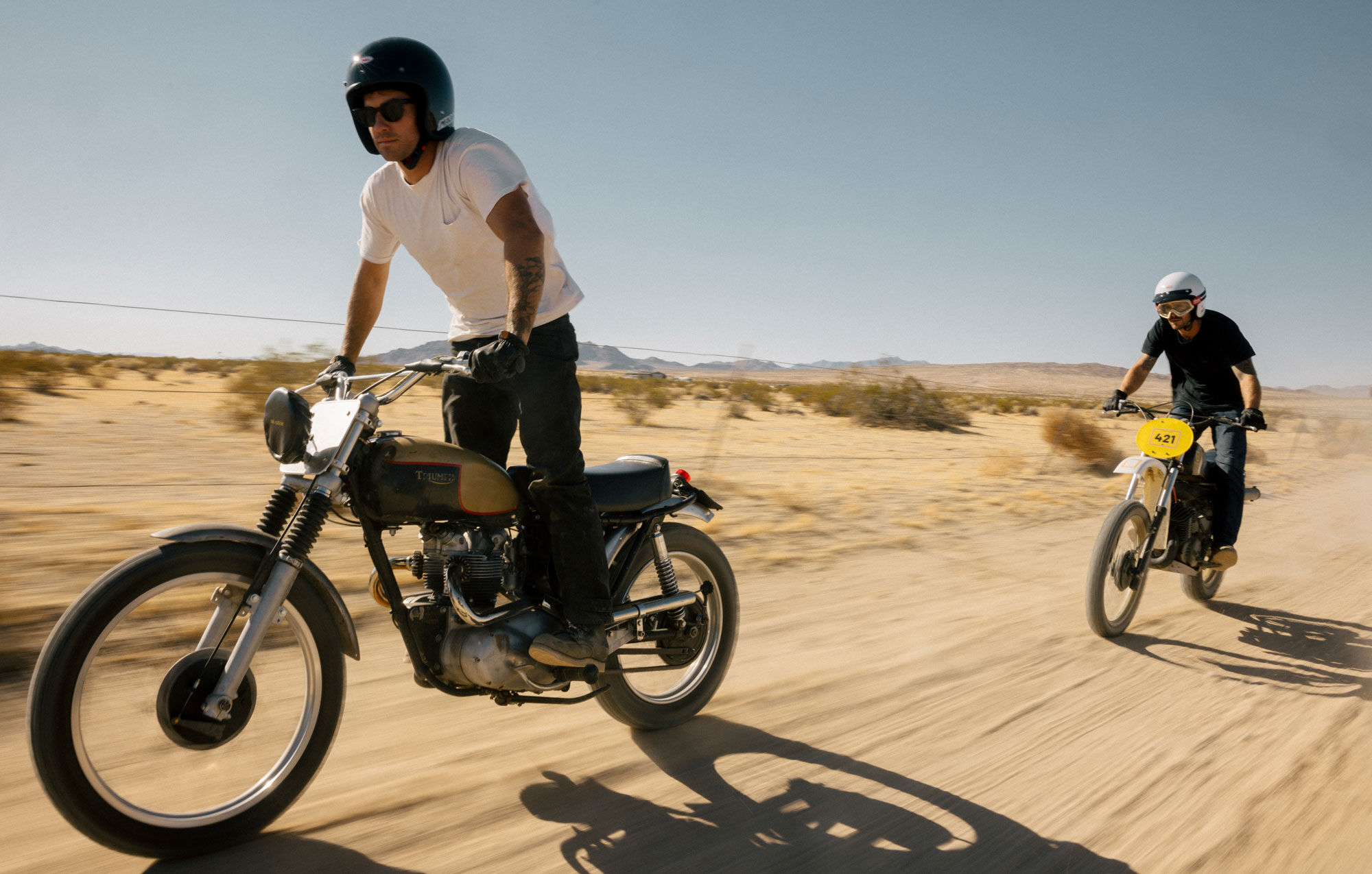 Two riders in the desert wearing Magnum helmets